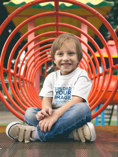 Smiling Little Boy Wearing a Tshirt Mockup While at the Playground