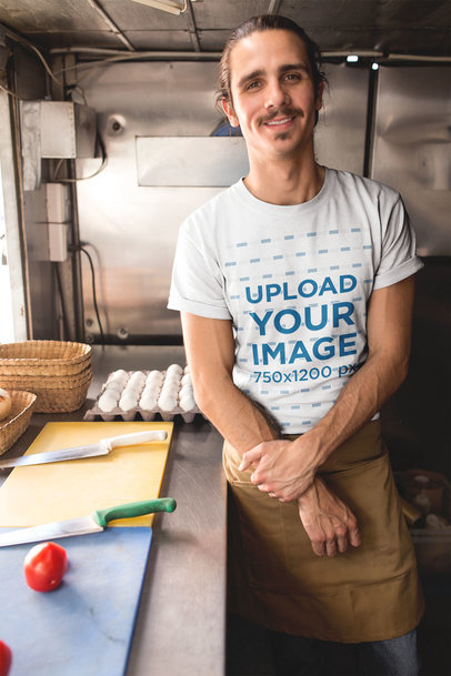 Happy Hipster Man Wearing a Tshirt Mockup Inside his Foodtruck