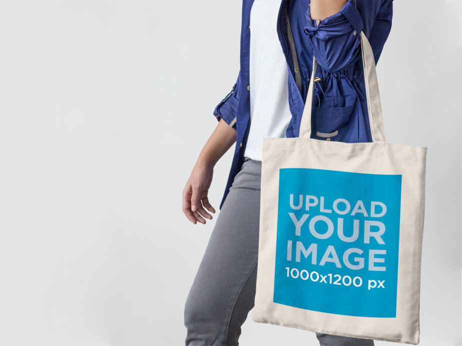 Placeit Mockup of a Canvas Tote Bag Being Carried by a Young Woman