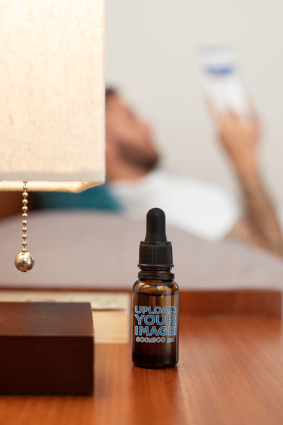 Download Placeit Cbd Oil Dropper Bottle Mockup With A Man Reading In The Background