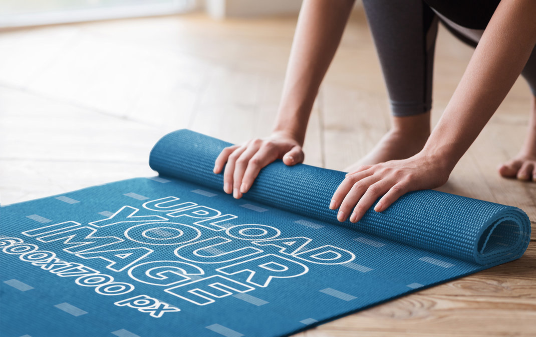 Placeit Mockup of a Woman Rolling Up Her Sublimated Yoga Mat