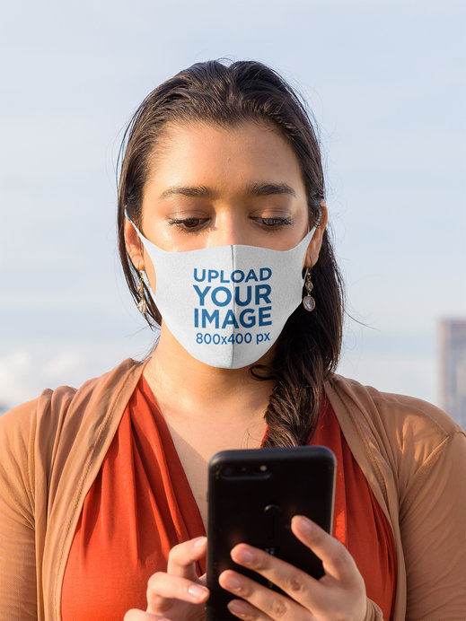 Placeit Face Mask Mockup Featuring a Serious Woman Texting