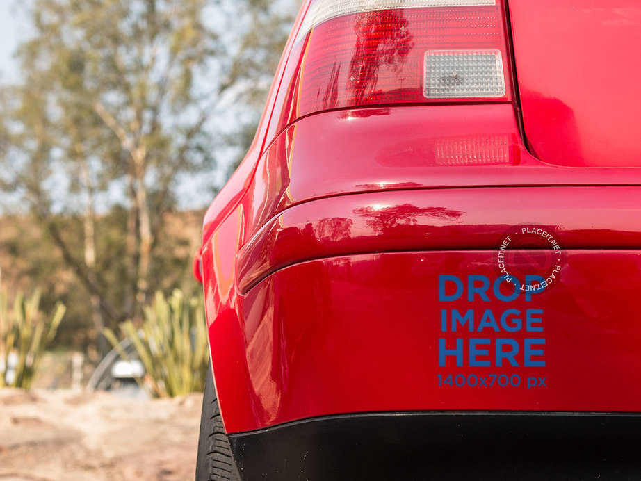 Placeit Square Sticker Mockup in the Back Bumper of a Red Car